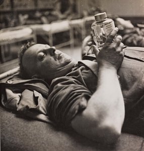Military convalescent examining a small bottle with a chemical preparation by Luigi Leoni