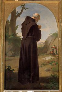 Monk praying in front of a tomb