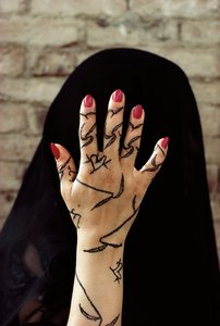 Yemenite woman with her hands decorated with henna dye in North Yemen