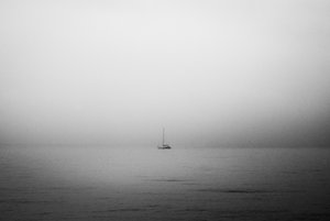 Lonely Sailboat In Fog