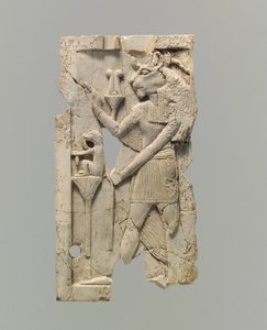 Furniture plaque carved in relief with lion-headed figure
