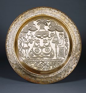 An Efik Brass Charger Embossed with a Central Robed Female Figure and Two Servants Holding a Fan and an Umbrella