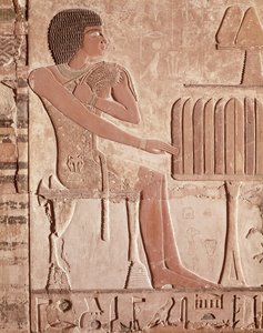 Relief depicting the deceased seated before an offering table with bread by Old Kingdom Egyptian