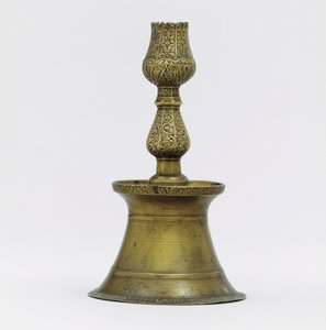An Ottoman brass candlestick, the neck with incised arabesque decoration rising into the shape of a tulip by Ottoman School