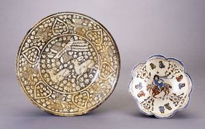 A Sultanabad pottery dish, depicting two seated deer amongst dense leafy motifs