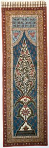 A glazed cotton kalimkari painted and printed with parrots and further birds perched in the branches of a flowering, flame-shaped tree by Persian School