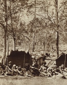 Australian Aborigines sheltering behind a windbreak