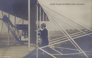 American aviator Orville Wright inspecting the engine of his aeroplane by Photographer German