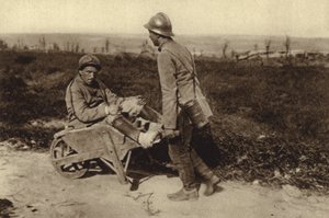 Captured French soldier transporting his wounded comrade in a wheelbarrow, World War I by Photographer German