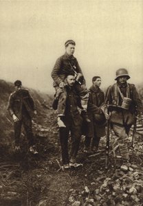 German infantryman with a leg wound being carried from the battlefield by British prisoners, World War I by Photographer German