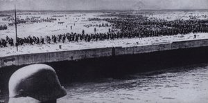 German soldier surveying Allied prisoners on the beach at Dunkirk, France, World War II, June 1940 by Photographer German