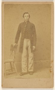 Unidentified Confederate soldier, standing by Samuel A. Cooley