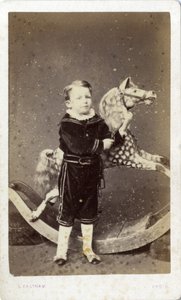 Young Boy Standing by a Rocking Horse by Silas Eastham