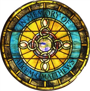 A circular leaded glass window by Tiffany Studios