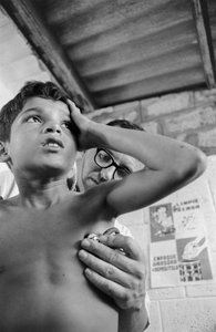 American doctor uses stethoscope to diagnose a sick Ecuadorian child on hospital ship SS Hope
