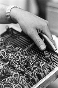 Computer operator Don Murray working with IBM early digital computer that uses punch cards