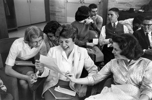 Teenage students share a letter with good news in a Sunday school class