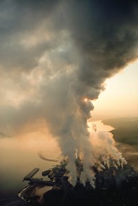 The pulp mill of MacMillan Bloedel Ltd. belches smoke into the sky