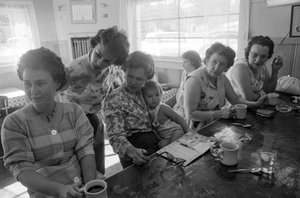 Women at a counter chat over breakfast in a diner in Oregon by Ted Spiegel