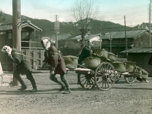 Japanese Peasants Pulling Sacks of Rice on a Cart, circa 1900 - 1915