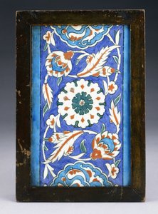 An Iznik Border Tile, with a Central Flowerhead between Scrolling Palmette and Leafy Vine by Turkish School