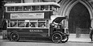 A double-decker bus standing outside the Law Courts, London, 1926-1927