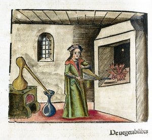 Alchemy 16th Century: An Alchemist at Work, Operating a Bellows in Front of His Workshop Fireplace, with a Stove and Alembic Behind Him