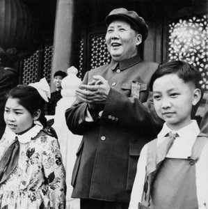 Chairman Mao Zedong applauding paraders from the rostrum at Tien An Men in Beijing, China