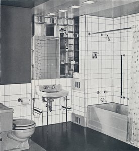 Crane Co. - A compact recess tiled in canary yellow, scored with orange, showing the stainless-steel