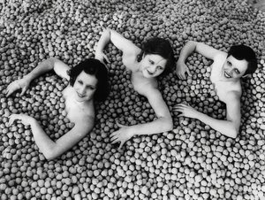 Three Young Women Bathing in a Sea of Walnuts by Unbekannt