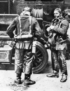 Firefighters donning smoke helmets, Farringdon Street rubber works, London