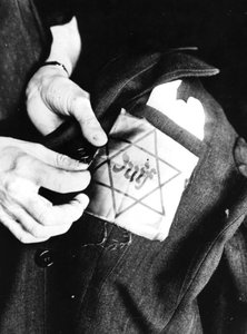 Sewing the Yellow Star Identifying a Jew onto a Jacket, German-occupied Paris by Unbekannt