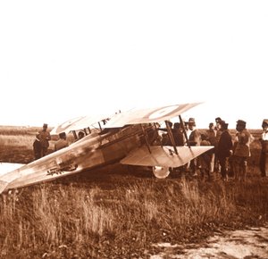 Soldiers surrounding biplane, Somme, northern France