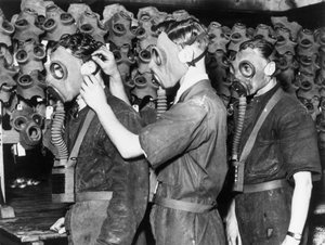 Three men wearing gas masks, c 1930s