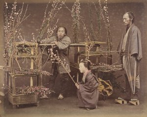 Two Japanese Men and One Japanese Woman Posing with Flowering Branches, 1870s