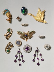 Selection of jewellery: amethyst and diamond chandelier earrings; cabochon star sapphire and diamond brooch; black opal ring; amethyst and diamond brooch or pendant; gold flying swan clip brooch; Tiffany & Co.