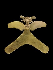 A Costa Rican gold avian pendant, the predatory bird cast with an openwork beak, grasping a small curly tailed animal, c.800-1200