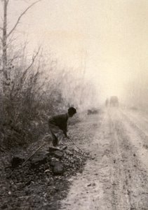 A Country Road Wrapped in Morning Mists with a Man Splitting Stones in the Foreground by Unbekannter Künstler