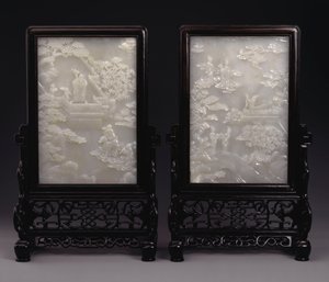 A pair of white jade table screens carved in relief with immortals amid clouds or in gardens with attendants and mythical beasts by Unbekannt