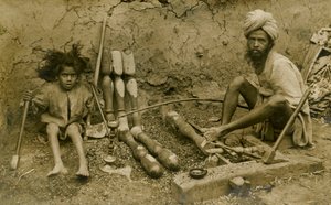 Carpenter and child working on bed legs