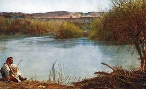 Jordan river - Arab hunter seated on river bank