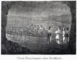 Salt mine: a group of visitors crossing the underground salt lake of the mine on a boat, in Durrnburg, Austria by Unbekannt