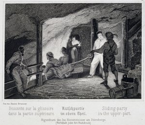 Salt mine: visitors installing in the upper part of the slide leading into the underground of the mine, in Durrnburg, Austria by Unbekannt