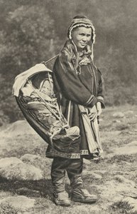 Sweden. Lapp woman carrying her baby in a cradle of reindeer skin. 1920