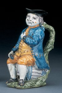 Toby jug with pale manganese face and hands, holding an empty globular buff-coloured jug in washed blue jacket and breeches, and green waistcoat, c.1800 by Unbekannt