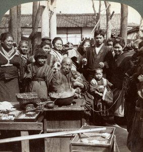 A street performer with a monkey amusing the crowd, Kobe, Japan, 1896