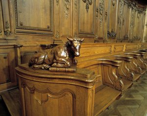 Baroque architecture: wooden stall representing an ox, attribute of the evangelist Saint Luke. Choir (18th century) of the Church of St. Stephen. Internal view. Marmoutier, Bas Rhin