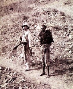 An Italian soldier and an Abyssinian prisoner on the road to Ghinda. by Unknown photographer