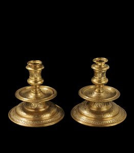 Pair of candlesticks of engraved brass, with later reworking, gilding and addition of removable sockets and wood bases, 1500-25