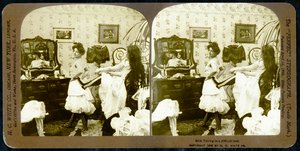 Stereoscopic card depicting a woman being laced into a corset, c.1900 by Vermont, USA H.C. White Company